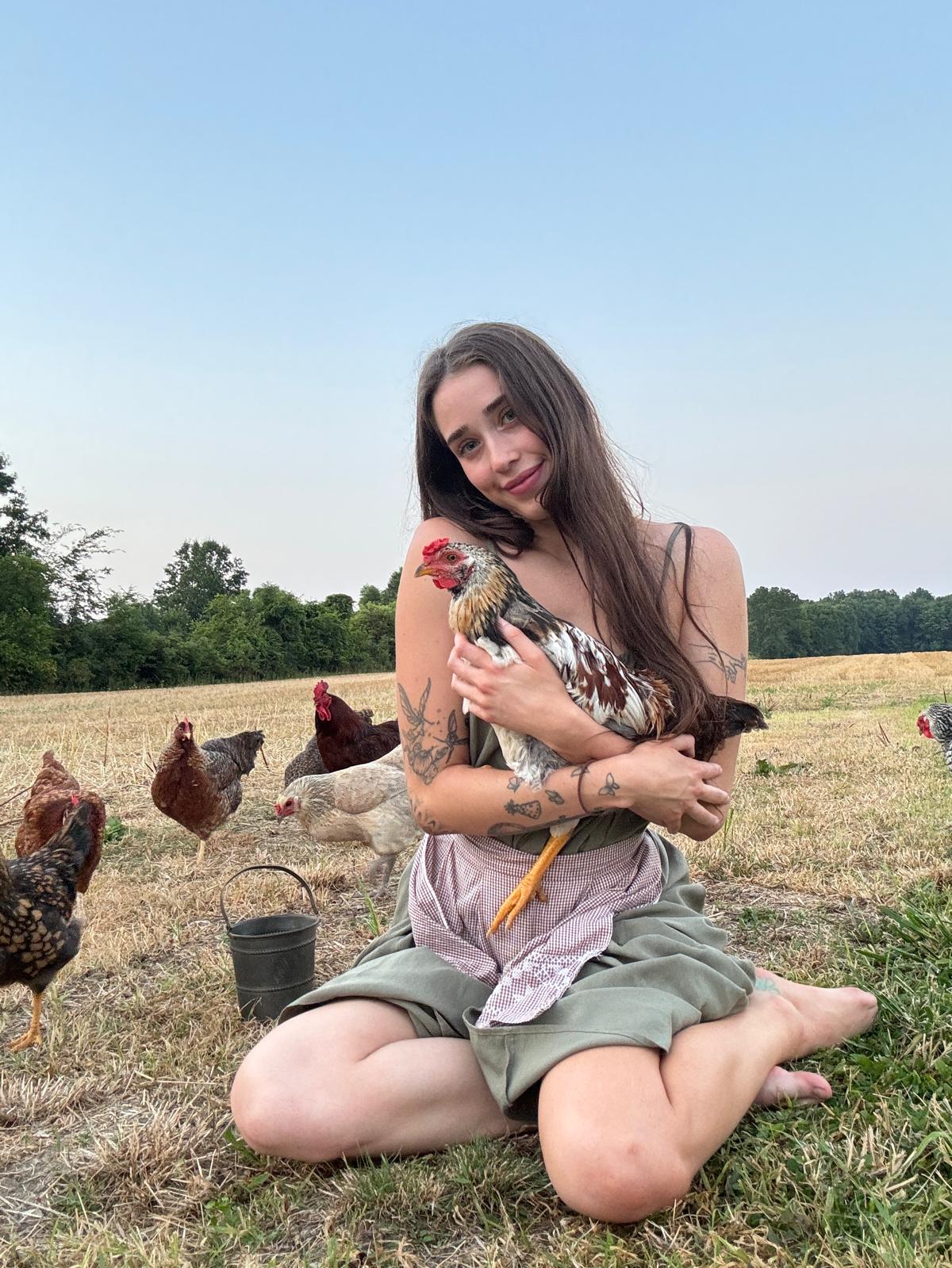Livinia with chickens in a field